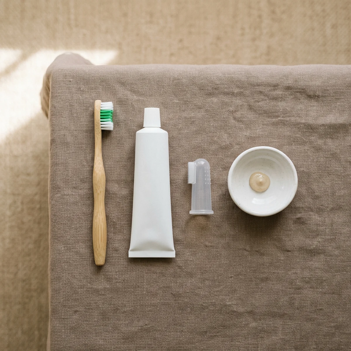 Dog toothbrush and enzymatic toothpaste arranged on a neutral surface